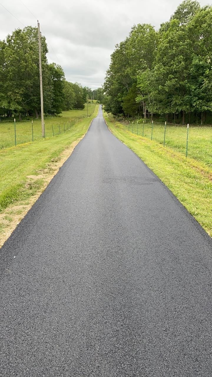 Long paved driveway with stone border