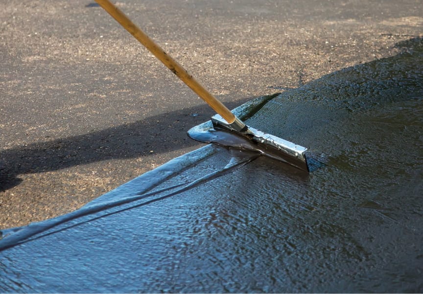 Fresh sealcoat applied to an asphalt driveway