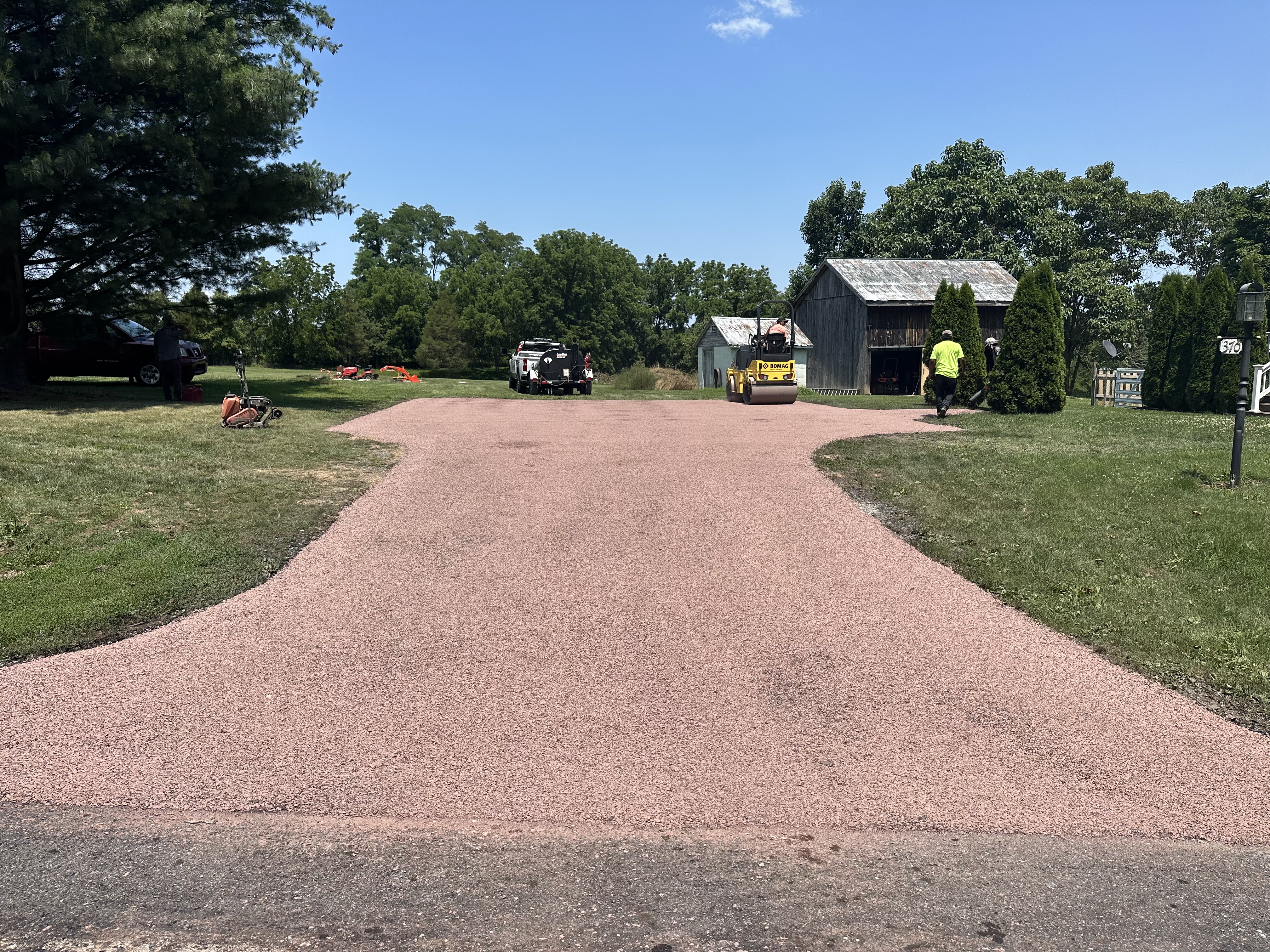 Chip seal surface being rolled into place