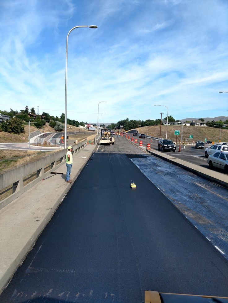 Industrial asphalt paving near a steel-frame building