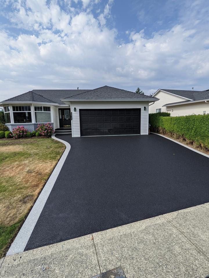 Modern Fort Wayne home with a freshly paved asphalt driveway
